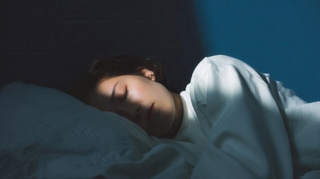 Young woman sleeping peacefully in bed with blue ambient light symbolizing deep relaxation rest and nighttime