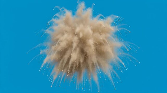 Sand powder explosion bursting against a solid blue background in slow motion, particles scattering and dissipating for creative transition or abstract energy