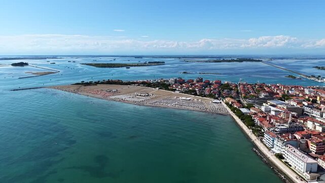 Grado, Italy with coastline, sea, and old town architecture during summer