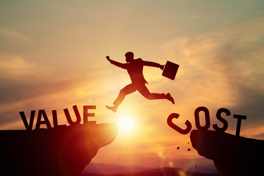 Silhouette of businessman jumping over cliff from value to cost word. Business strategy, price optimization, financial balance, corporate risk management, and success achievement concept.