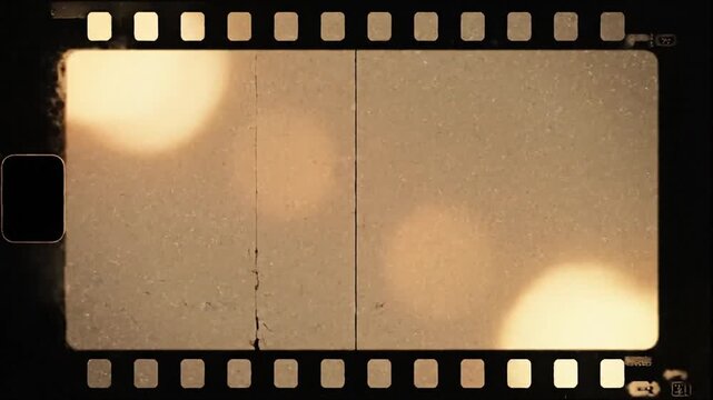 Vintage film strip with blurred warm bokeh lights creating nostalgic cinematic atmosphere