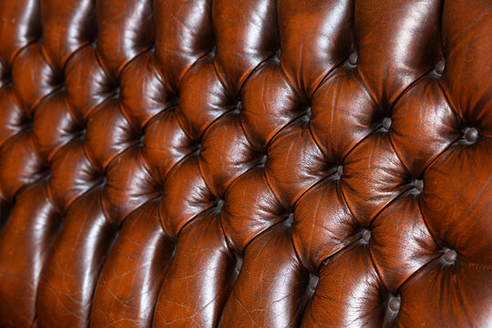 Classic brown leather Chesterfield sofa close up