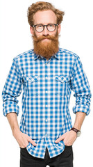 Fototapeta premium A bearded man in glasses and a checkered shirt stands against a white background, embodying casual style and confidence.
