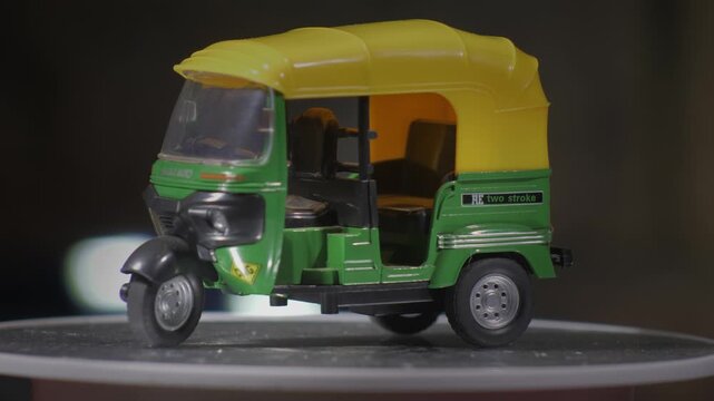 Miniature model transporter green and Yellow toktok bajaj rotating on turntable no doors generic fast