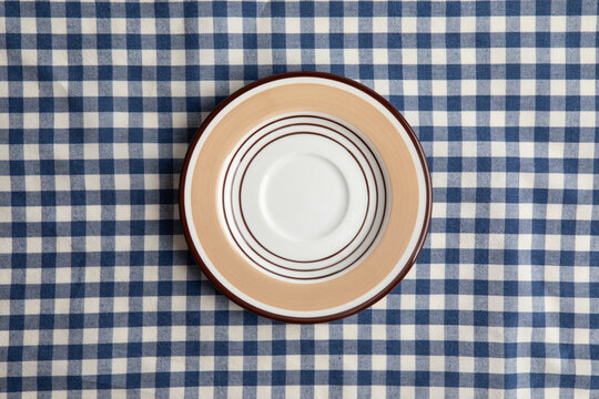 A plate on a blue and white checkered tablecloth