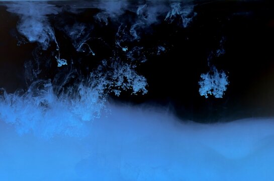 Blue color dye melt on black background,Abstract smoke pattern,Colored liquid dye,Splash paint