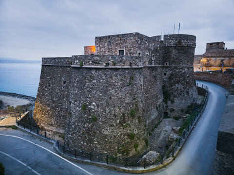 Blue hour view of Castello Murat in Pizzo, Calabria, Italy, photographed on 17 April 2026. Historic coastal fortress with massive stone walls and defensive towers overlooking the Tyrrhenian Sea before