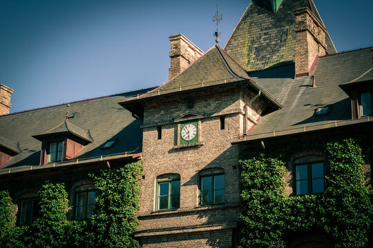 Alnarps slott with ivy-covered brick facade and clock in warm sunlight, Sk&aring;ne