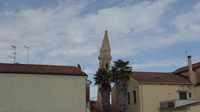 Quiet Mediterranean Cityscape With Church Tower and Moving Palms