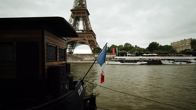 River view in Paris with the Eiffel Tower, Seine River, and French flag