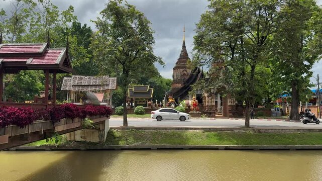 A beautiful view of Wat Lok Moli, a historic Buddhist temple in Chiang Mai, Thailand, captured from across the city moat