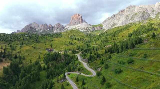 Stunning aerial footage of the winding mountain road of Passo Giau, with the majestic Ra Gusela peak in the beautiful Italian Dolomites