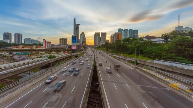 Timelapse of Highway Traffic Moving Toward City Skyline During Vibrant Sunset in Klang Valley in Malaysia