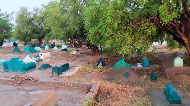  A Peaceful View of a Graveyard in Pahar Pur Layyah Pakistan.  Musalman qabristan. people's last destination. world and muslims final resting place. Graveyard. Digging soil with shovel. 4K Footage.