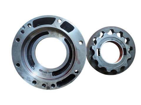 Gerotor internal gear set inside its circular flange housing for automotive or industrial oil pump isolated on black background.