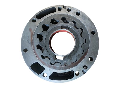 Gerotor internal gear set inside its circular flange housing for automotive or industrial oil pump isolated on black background.