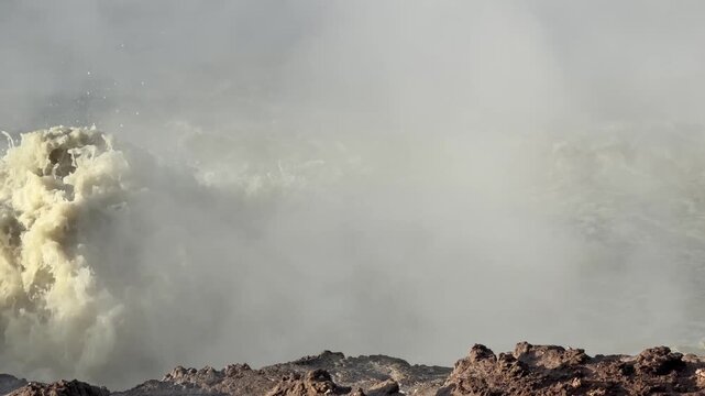 Yellowstone National Park - Boiling mud at Churning Caldron viewed from the Mud Volcano Trail