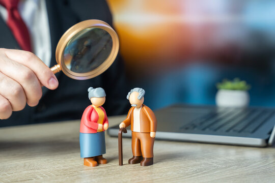 Elderly pensioners grandfather and grandmother standing at the work table. Pension policy, discussing retirement savings, insurance plans, social security benefits, and financial stability for old age
