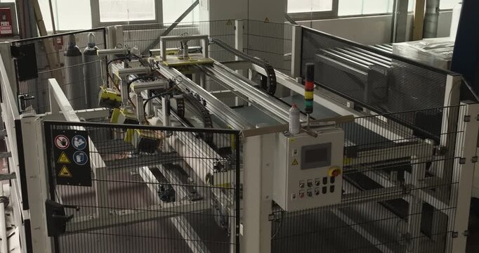 Automated industrial conveyor system moving a large pallet in a warehouse