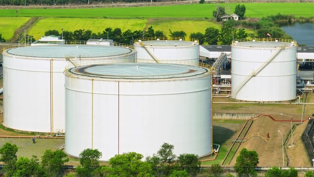 Aerial drone capture of oil storage tanks and industrial systems, representing the balance between traditional fuel reliance and the evolving transition toward diversified global energy sources.
