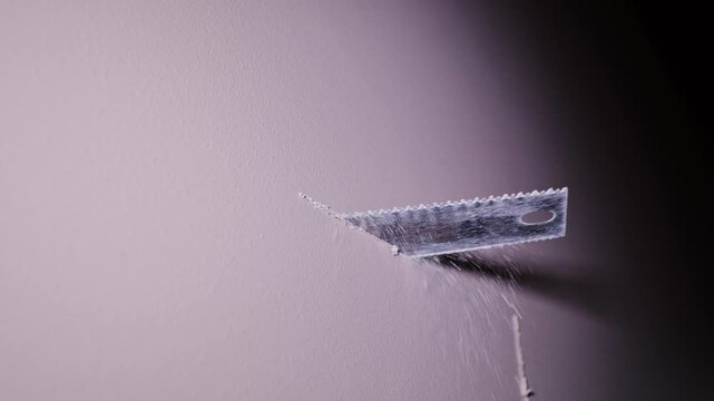 Close Up of Drywall Cutting Process Creating Opening for Building Services