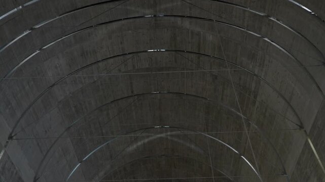 Curved concrete vaulted ceiling with arched lines in modern minimalist architecture interior
