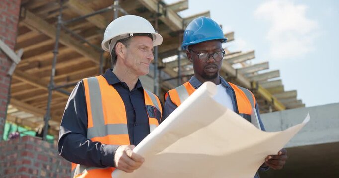 Construction, men or site inspection with blueprint for building update, phase assessment or layout. Floor plan, architect and foreman talk outdoor for safety regulations, renovation progress or team