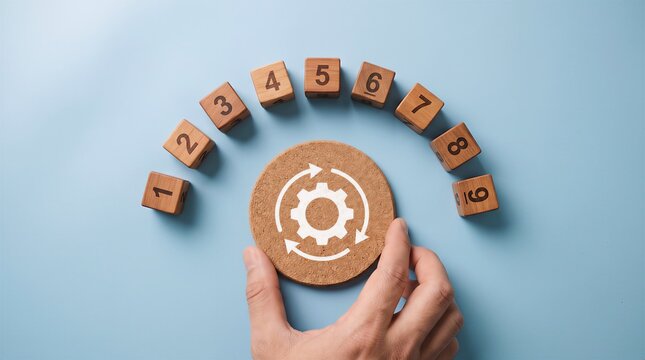 Hand selecting gear icon wooden block among numbered sequence on blue desk with business management strategy development optimization sequence efficiency workflow