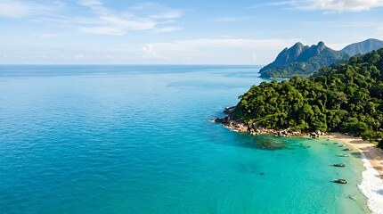 Fototapeta premium Aerial view of a tropical turquoise bay with lush green mountains