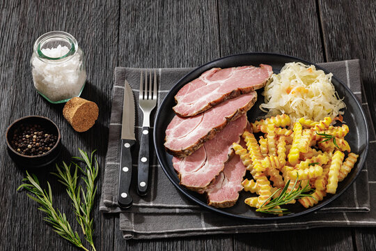 pork neck slices with sour cabbage, french fries