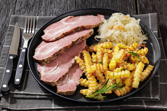 pork neck slices with sour cabbage, french fries