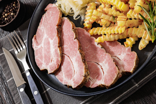 pork neck slices with sour cabbage, french fries