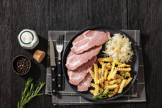 pork neck slices with sour cabbage, french fries