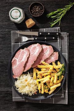pork neck slices with sour cabbage, french fries
