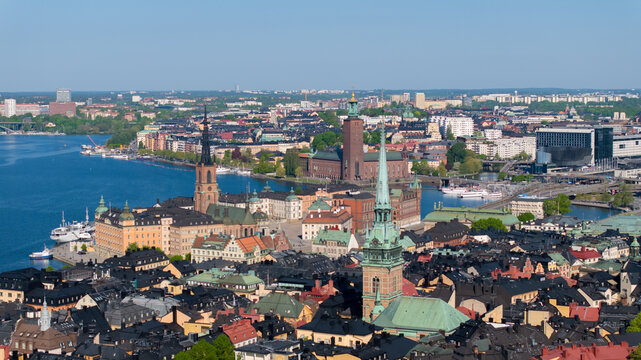 Aerial view of the historic Gamla Stan district, Stockholm City Hall, and Riddarholmen Church surrounded by the blue waters of Lake Malaren in Stockholm, Stockholm County, Sweden.