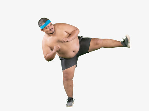 Energetic Overweight Asian Man Doing High Kick Exercise, Fun Fitness and Weight Loss Concept