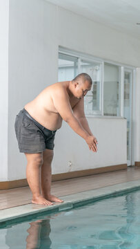 Overweight Asian Man Preparing to Dive into Swimming Pool, Fitness and Weight Loss Concept
