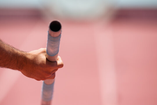 Pole vaulter prepares for jump, detail of vaulting pole