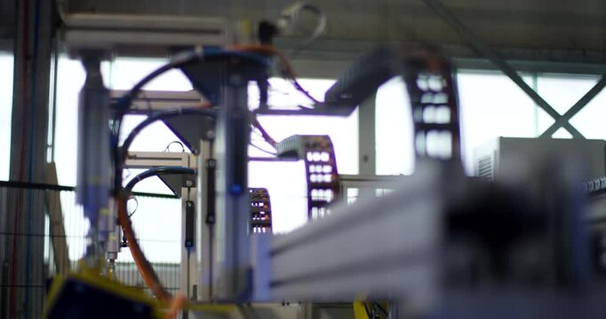 Automated mechanical arm moving in a factory production line setting