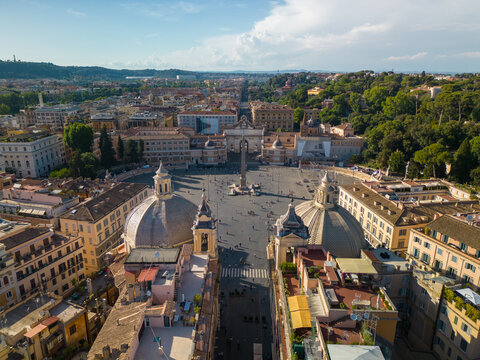 Aerial view of Piazza del Popolo featuring the twin churches and central obelisk surrounded by historic rooftops in Rome, Lazio, Italy.