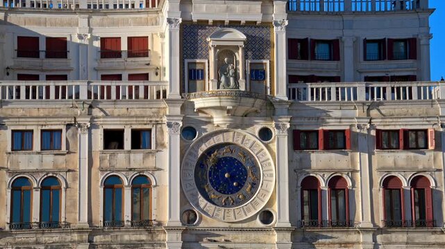 St Marks Clock tower in Venice showing zodiac details and astronomical dial during sunny bright day.