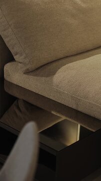 Vertical video. Close-up of modern sofa upholstery and furniture details in living room interior.