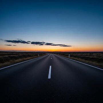 Empty asphalt road stretching into the horizon at sunset in iceland