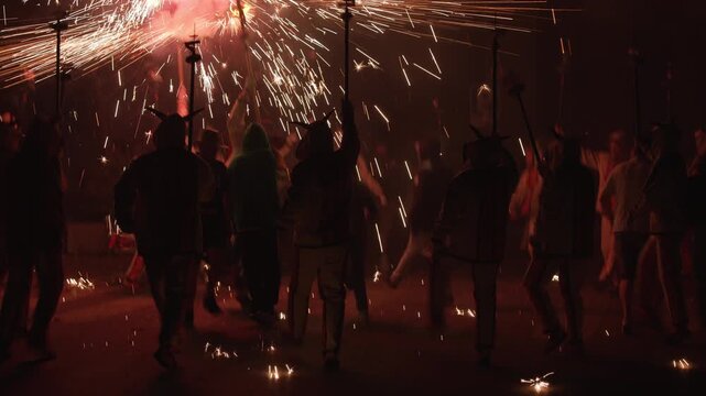 carnival in Catalunya, Spain, people dancing with fireworks and firecrackers during Correfoc, a festival of fire, traditional festival in Catalunya, Spain