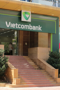 NHA TRANG, VIETNAM - JANUARY 26, 2026: A vertical view of the Vietcombank branch entrance featuring multiple stairs and the corporate green and white sign board.