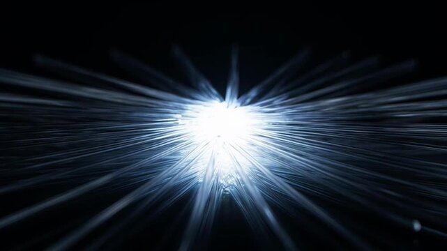 Abstract digital light burst with blue rays on black background.