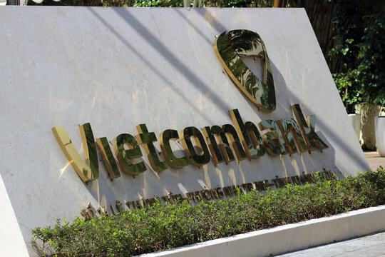 NHA TRANG, VIETNAM - JANUARY 26, 2026: Golden 3D corporate sign letters and logo of Vietcombank displayed on a building facade.