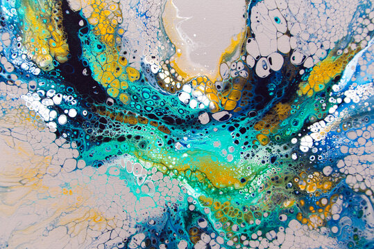 Abstract acrylic pour artwork on canvas. Bold tones of blue, green and accents of gold flowing patterns.