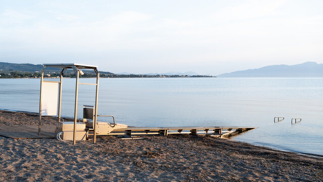 Sea Track system on accessible beach in Greece, providing independent sea access for people with mobility disabilities. Barrier-free tourism infrastructure by the calm seaside.