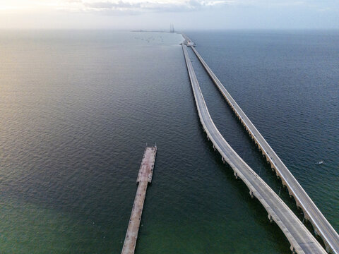 Aerial view of the long pier at Puerto Progreso extending into the Gulf of Mexico, with calm waters and a clear horizon in Progreso, Yucatan, Mexico.